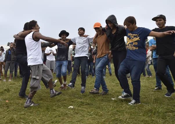Locals gather with migrants seeking asylum in Germany for a welcome fest at the migrants shelter on August 28, 2015 in Heidenau. Picture: Getty Images