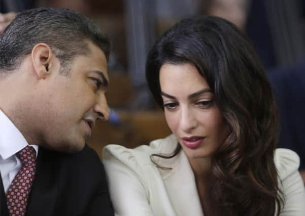 Mohammed Fahmy (left) talks to his lawyer Amal Clooney. Picture: AP