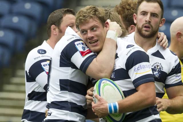 Iain Wilson is congratulated by his Heriots team-mates after scoring a second-half try at Murrayfield. Picture: Ian Rutherford
