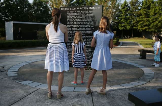 A moment of silence at the New Orleans Katrina Memorial, where unclaimed or unidentified victims are interred. Picture: Getty