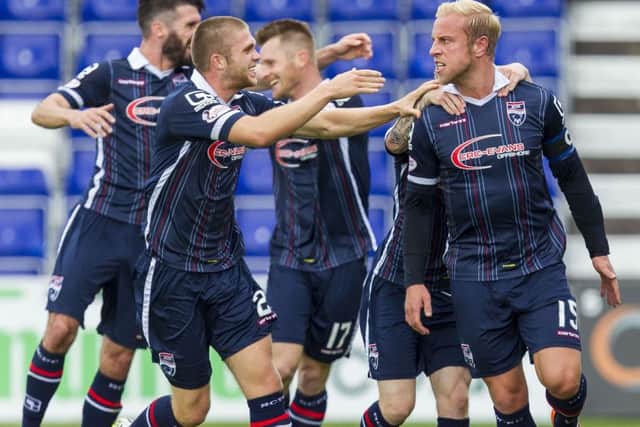 Andrew Davies is mobbed after netting Ross County's second. Picture: SNS