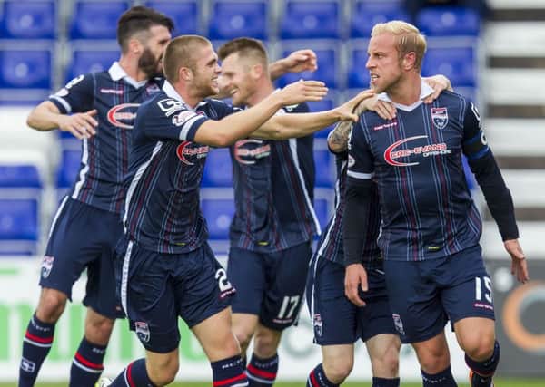Andrew Davies is mobbed after netting Ross County's second. Picture: SNS