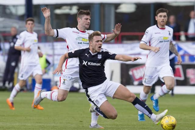 Iain Vigurs challenges Dundee's Greg Stewart as Inverness were denied a first victory of the season. Picture: SNS