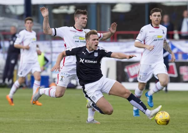 Iain Vigurs challenges Dundee's Greg Stewart as Inverness were denied a first victory of the season. Picture: SNS