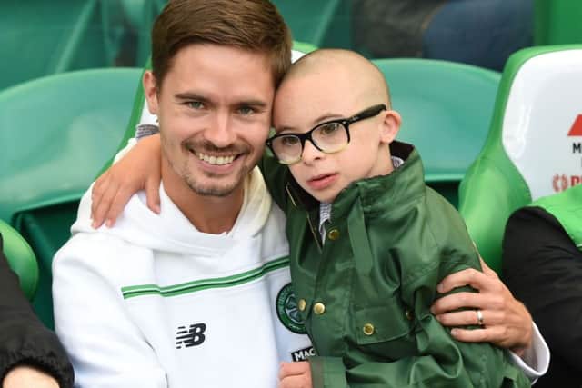 Jay Beatty shares a seat on the bench with Celtic defender Mikael Lustig. Picture: SNS