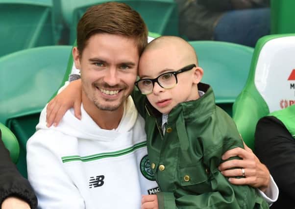 Jay Beatty shares a seat on the bench with Celtic defender Mikael Lustig. Picture: SNS