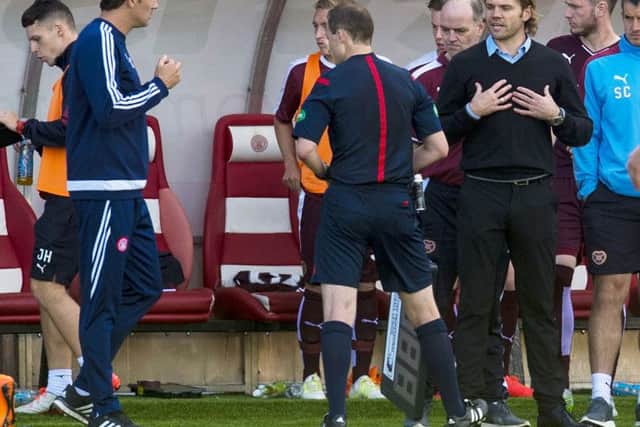Hearts' manager Robbie Neilson (right) argues with officials in the dugout. Picture: SNS