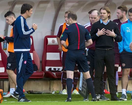 Hearts' manager Robbie Neilson (right) argues with officials in the dugout. Picture: SNS