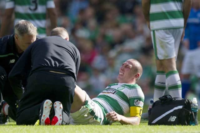 Scott Brown receiving treatment after injuring his knee during Celtics victory over St Johnstone. Picture: SNS