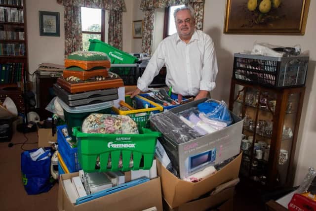 Chris Rae with some of the junk mail and charity requests sent to his father Samuel. Picture: SWNS