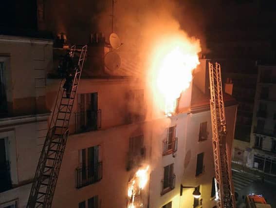 Firefighters battle the blaze at the apartment building in Montmartre in the north of Paris early yesterday. Picture: AFP/Getty