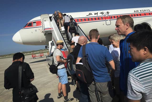 Passengers board an Air Koryo plane at Pyongyang International Airport, North Korea. Picture: AP
