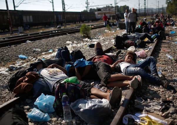 Peopl lie down on the railway line at the Greece-Serbia border. Picture: Getty