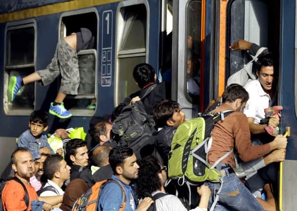 Refugees board a local train heading to the Hungarian-Austrian border at the main train station in Budapest. Picture: AP