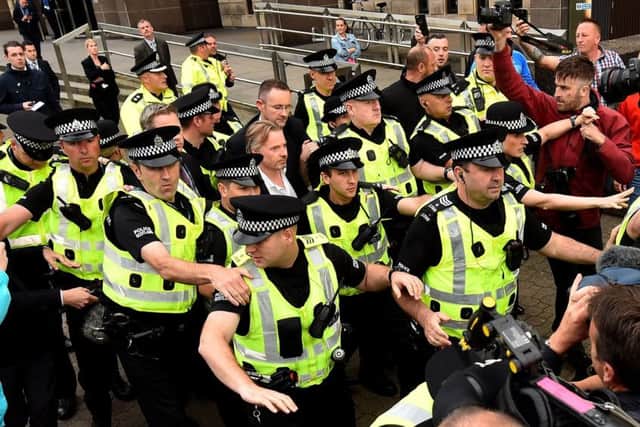 Craig Whyte, who took over Rangers before the club went into administration, leaves court on Wednesday, surrounded by police. Picture: Getty