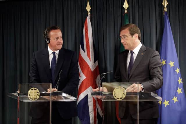 Prime Minister David Cameron, left, listens to his Portuguese counterpart Pedro Passos Coelho in Lisbon. Picture: AP