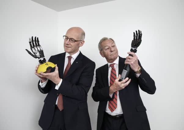 John Swinney and Archangels co-founder Mike Rutterford get to grips with new technology. Picture: Robert Perry