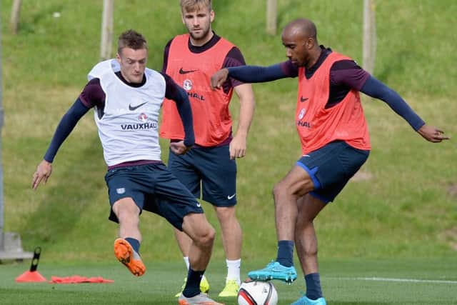 England trio Jamie Vardy, left, Luke Shaw, centre, and Fabian Delph vie for the ball in training. Picture: Getty