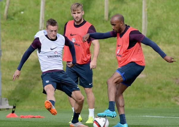 England trio Jamie Vardy, left, Luke Shaw, centre, and Fabian Delph vie for the ball in training. Picture: Getty