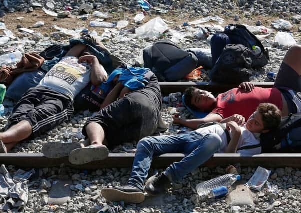 Syrian refugees sleep on railroad tracks waiting to be processed across the Macedonian border in Idomeni, Greece. Picture: Getty