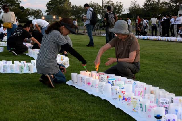 People light candles in Naraha town to celebrate the lifting of the evacuation order. Picture: AFP/Getty