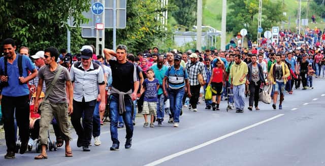 A group of about 500 refugees march along a Hungarian road towards the border. Picture: AFP/Getty