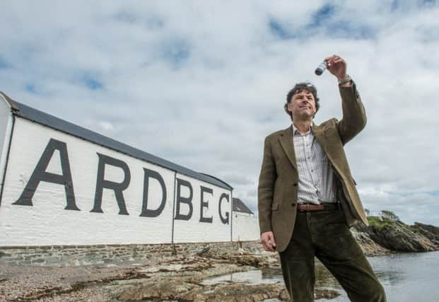 Director of distilling Dr Bill Lumsden with the sample of Ardbeg from space. It is said to be more 'phenolic'. Picture: PA