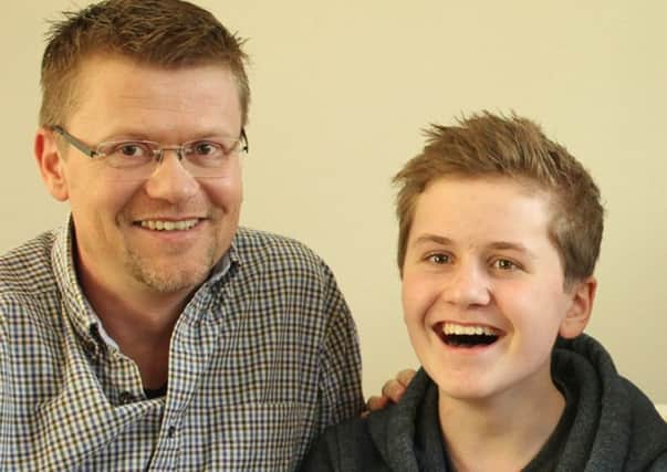 Esten, who has undergone the therapy and returned to school, with his father Carl. Picture: PA