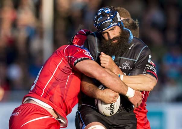 Glasgow's Josh Strauss, who will join the Scotland World Cup squad later this month, tries to break a tackle in his side's 16-10 loss to the Scarlets. Picture: SNS/SRU