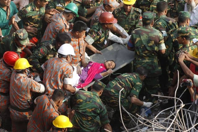 Rescue workers carry Reshma Begum from the collapsed building. Picture: AFP/Getty Images