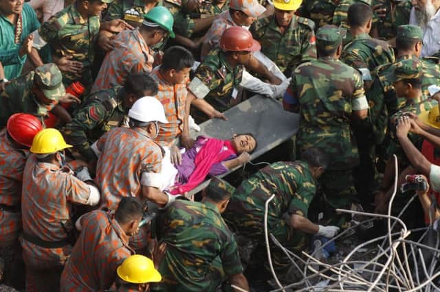 Rescue workers carry Reshma Begum from the collapsed building. Picture: AFP/Getty Images