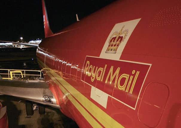 Mail is loaded on to a plane at Edinburgh airport. Delivery charges have soared. Picture: Getty