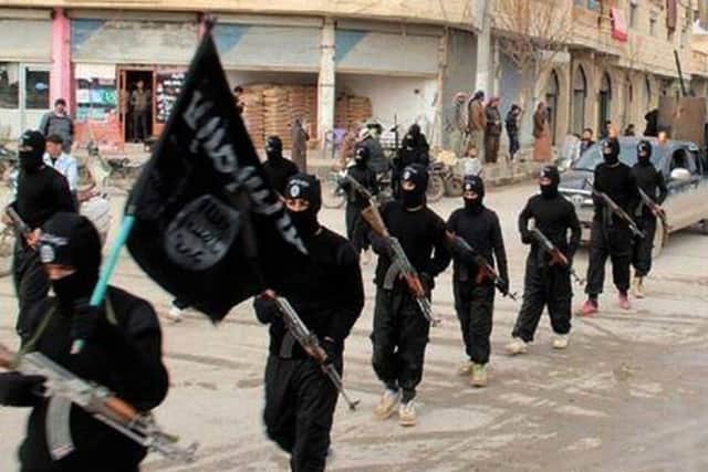 IS militants march in Raqqah, Syria. Pic: AP