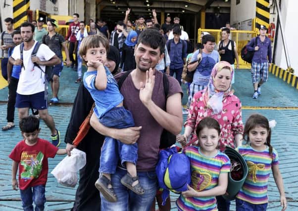 Immigrants and refugees arrive in a ferry carrying about 2,500 migrants from Greek island Lesbos to Greece's main port near Athens. Picture: Getty Images