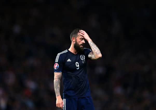 Scotland's Steven Fletcher stands dejected after being defeated by Germany at the end of their Euro 2016 Group D qualifying match. Picture: Getty Images