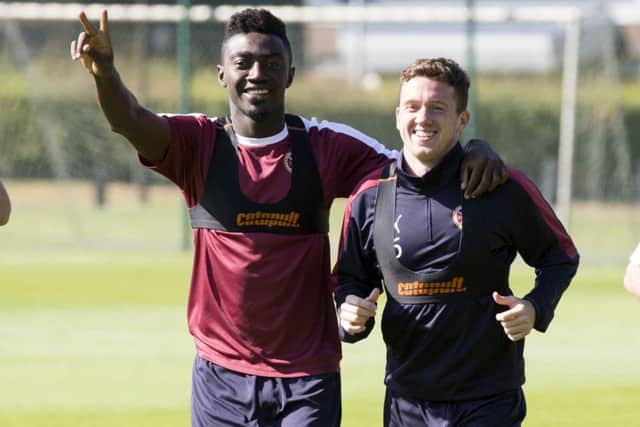 Hearts signing Danny Swanson reacquaints himself with former Dundee United team-mate Prince Buaben at training yesterday. Picture: SNS
