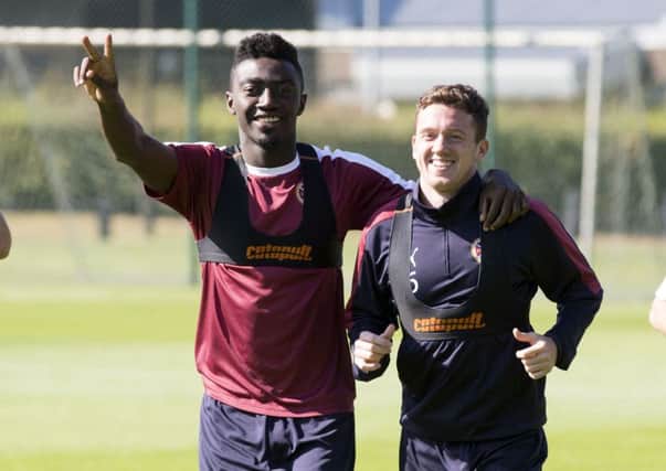 Hearts signing Danny Swanson reacquaints himself with former Dundee United team-mate Prince Buaben at training yesterday. Picture: SNS