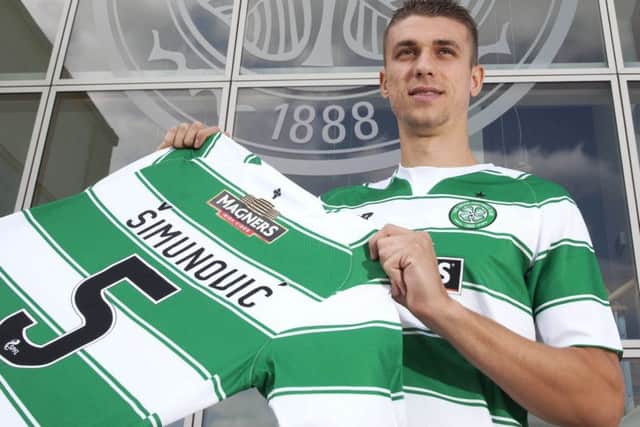 Jozo Simunovic dons his new colours at Celtic Park. Picture: SNS