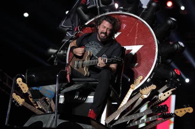 Dave Grohl appeared on a Game of Thrones type seat after breaking his leg. Picture: Getty