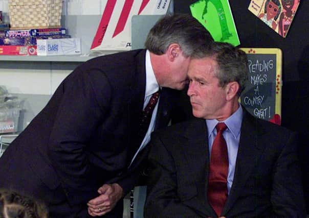 Chief of staff Andy Card whispers into the ear of President Bush to give him word of the World Trade Center attacks in 2001. Picture: AP