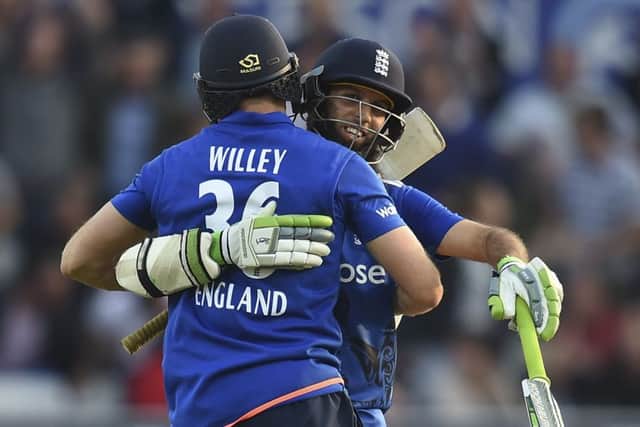 David Willey, left, embraces Moeen Ali after sealing Englands victory at Headingley. Picture: AFP/Getty Images