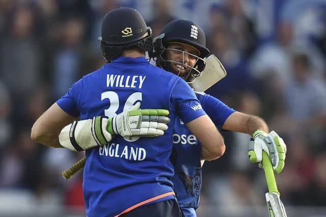 David Willey, left, embraces Moeen Ali after sealing Englands victory at Headingley. Picture: AFP/Getty Images