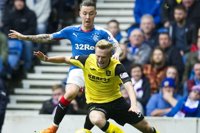 Barrie McKay, left, challenges for the ball with Livingston's Ross Millen. Picture: SNS