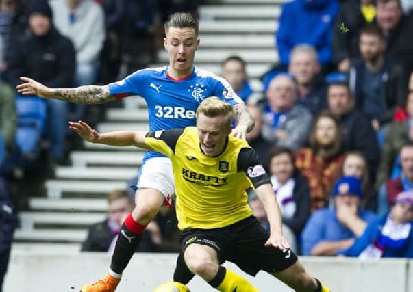 Barrie McKay, left, challenges for the ball with Livingston's Ross Millen. Picture: SNS