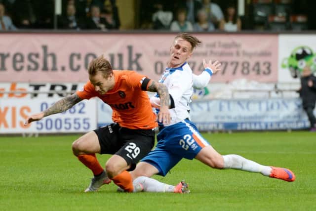 Dundee United's Adam Taggart is tackled by Kilmarnock's Kevin McHattie. Picture: SNS