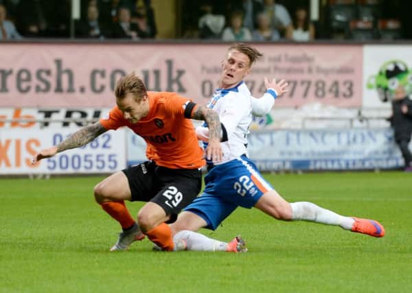 Dundee United's Adam Taggart is tackled by Kilmarnock's Kevin McHattie. Picture: SNS