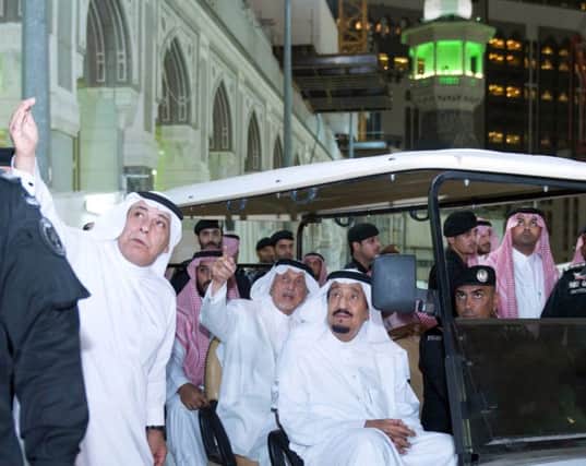 King Salman bin Abdulaziz, centre, tours the site of the accident inside the Grand Mosque at Mecca. Picture: AFP/Getty