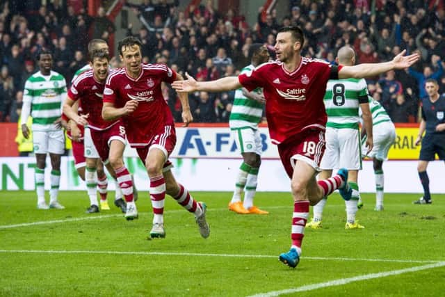 Paul Quinn wheels away in delight after poking home the match-winning goal. Picture: SNS