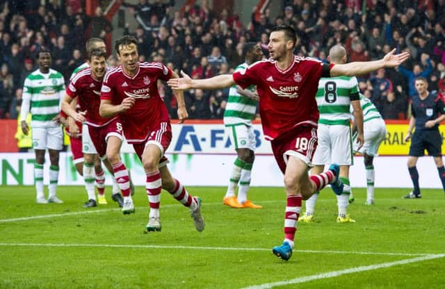 Paul Quinn wheels away in delight after poking home the match-winning goal. Picture: SNS