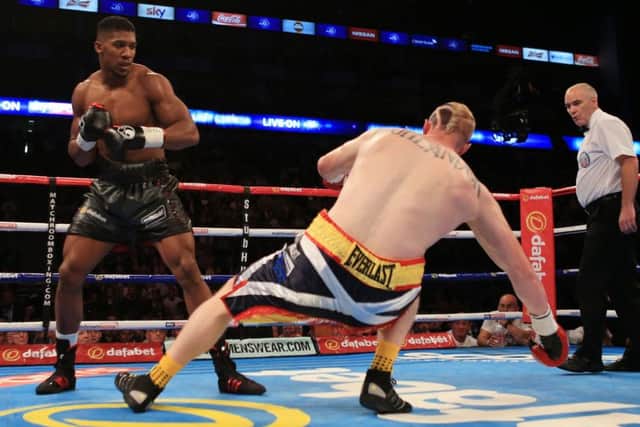 Anthony Joshua sends Inverness boxer Gary Cornish crashing to the canvas. Picture: PA